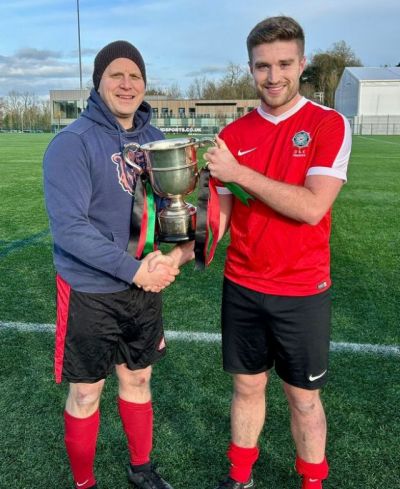 Steven Fleck receiving the McDowell Cup 2023 from League President Gary Busch